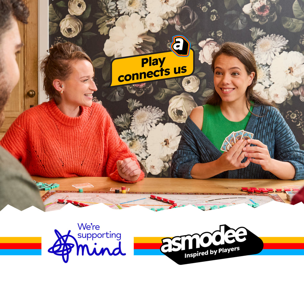 Two women playing a card game with an Amazon 'Play connects us' banner and Asmodee logo in the background.